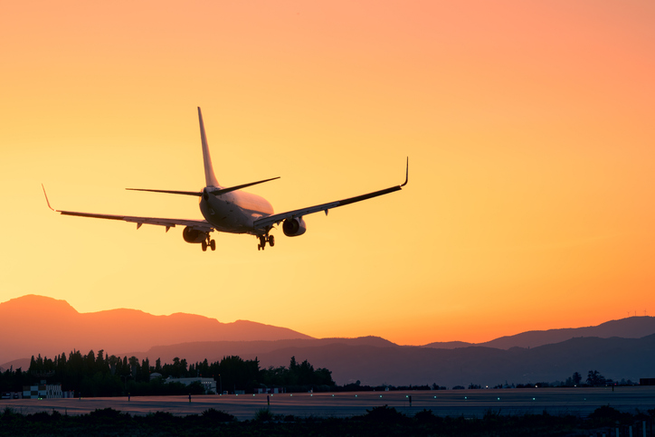 Epic landing with the sunset and the mountains, plane landing beneath a breathtaking sunset, sunset landing